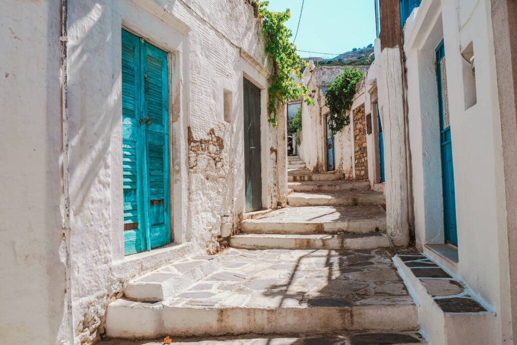 Iconic white buildings and blue doorways of the Cyclades islands of greece, to be reached by yacht charter.