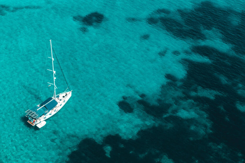Sailing greece on calm turquoise waters on a beautiful yacht.