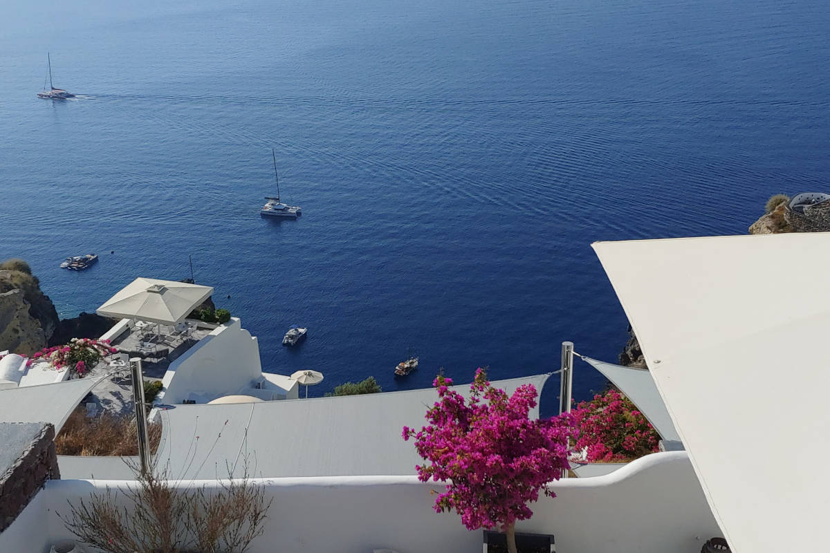 Yacht charter greece with view from the Santorini coastline.